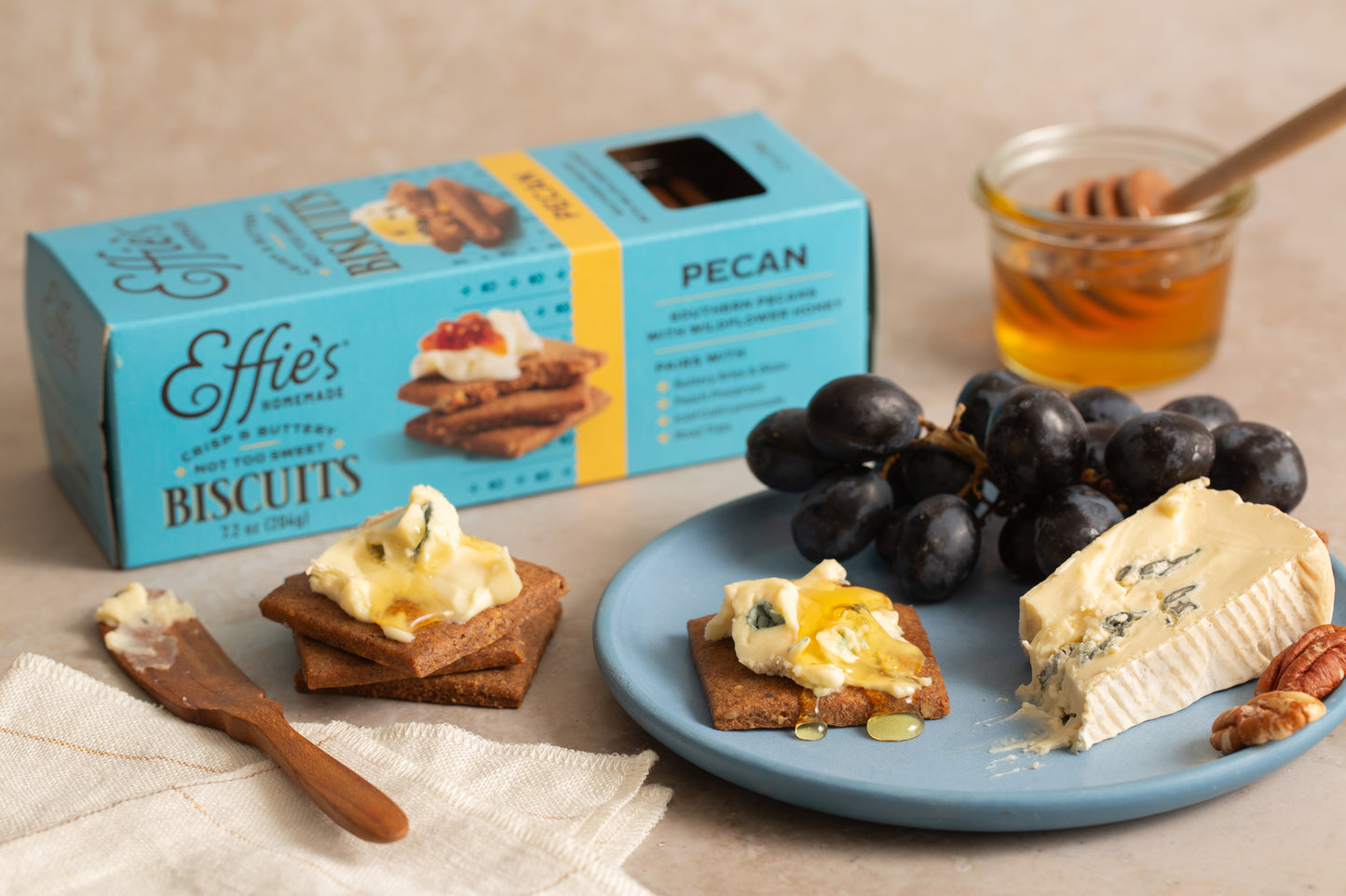 Effie's Pecan Biscuits paired with creamy blue cheese, a drizzle of honey, and toasted pecans, highlighting their rich and nutty flavor for elegant pairings.