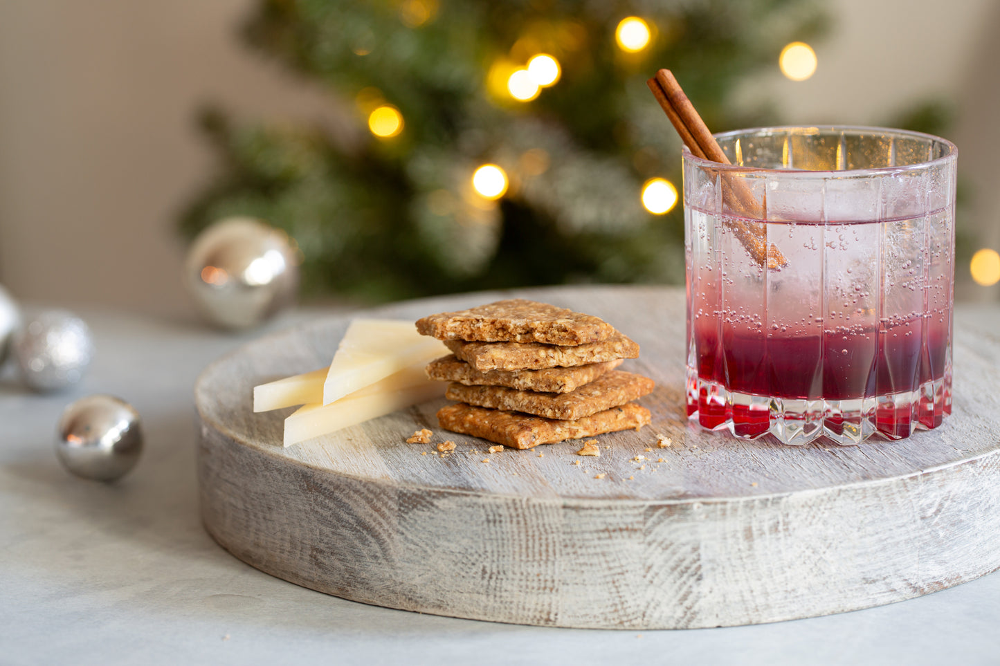 Effie's Gruyère Biscuits paired with sharp cheddar cheese and a holiday cranberry spritz.