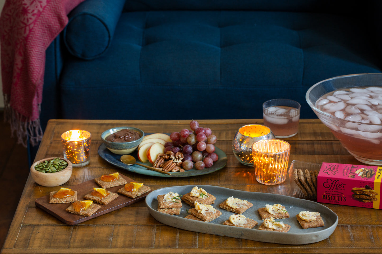 Effie's Walnut Biscuits arranged on a charcuterie board with assorted cheeses, fruits, and nuts.