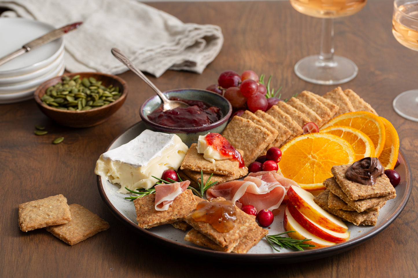 Effie's Hazelnut Biscuits alongside Oatcakes and Gruyère Biscuits, presented with assorted cheeses, nuts, jams, and fruit.