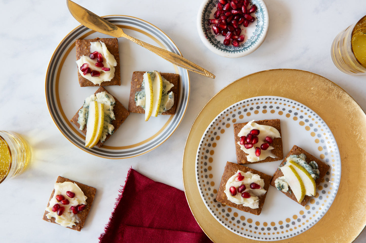 Effie's Ginger Biscuit paired with blue cheese, pear slices, and pomegranate seeds.